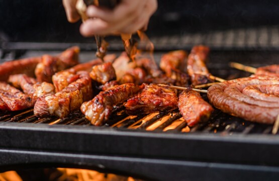 a person is cooking meat on a grill